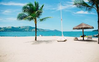 What are the hazards of driving on the beach during high winds?